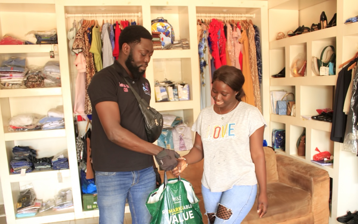 A delivery rider handing a customer her order