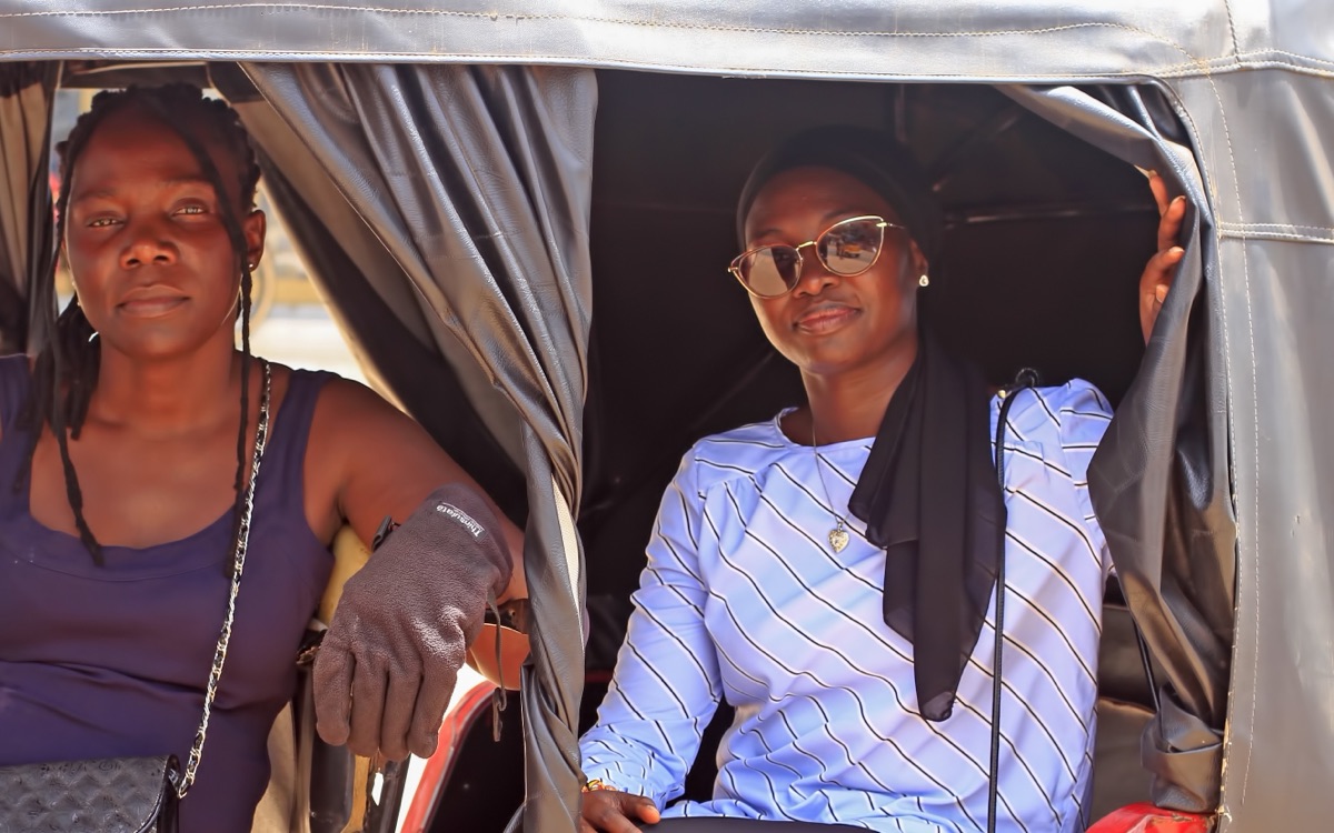 Two customers in their tricycle taxi